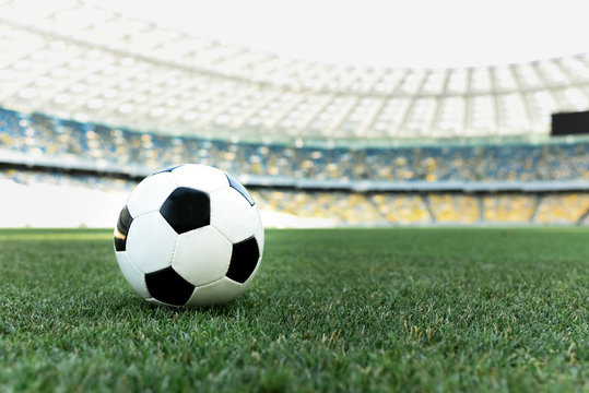soccer ball on grassy football pitch at stadium