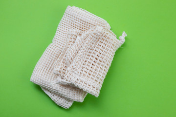 reusable cotton bags for food  on green paper background