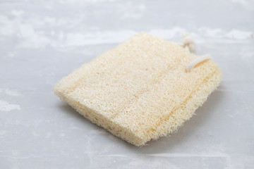 root vegetable scrubber on ceramic background