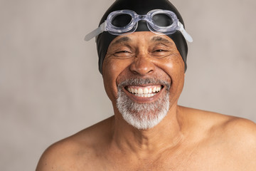 Senior African American swimmer wearing a swim cap and goggles