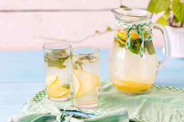 Cold lemonade with mint and ice for two on a hot summer day.