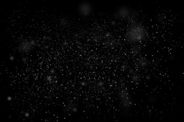 Dust particle on black abstract background. White dust element bokeh pattern flying in a dark