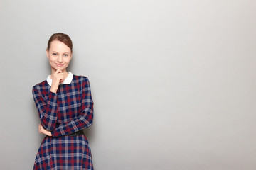 Obraz premium Portrait of happy girl touching chin with hand and smiling