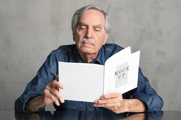Senior man reading a book mockup