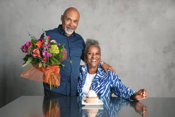 African American couple celebrating an anniversary together with flowers