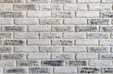 Light brick wall with dark stains