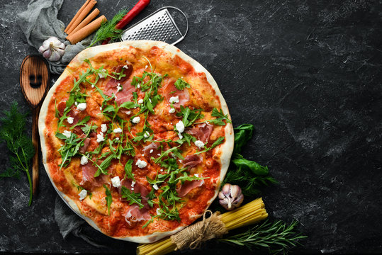 Pizza with prosciutto and cheese. Top view. Free copy space.