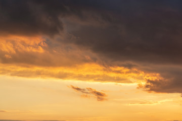 Fototapeta na wymiar orange sunset sky with lighted clouds