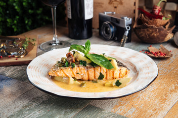 Grilled salmon fillet with sauce balsamic leaves
