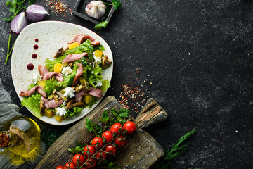 Vegetable salad with mushrooms and bacon on a plate. Top view. free space for your text. Rustic style.