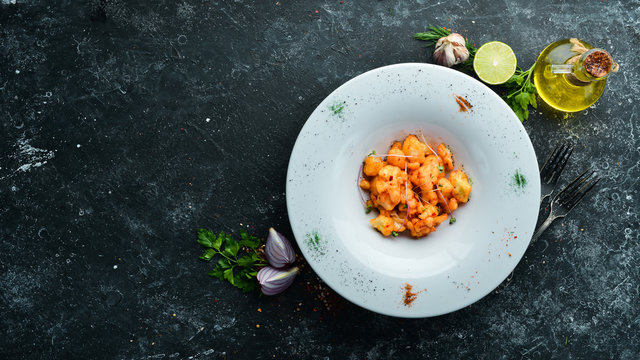 Roasted cauliflower with chili sauce on a plate. Top view. free space for your text. Rustic style.