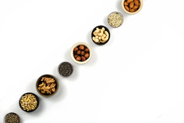 Nuts in round cup, top view close up. On white background. in round cup, top view close up. On white background.