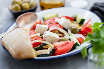 salad with fresh and grilled salad on white dish on gray ceramic background