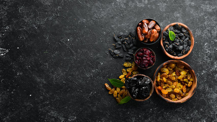 Set of dried fruits. Raisins, cranberries, dates and prunes. Top view. Free space for your text.