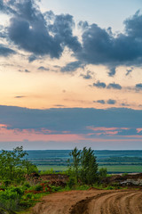 Obraz premium Summer landscape with field and country road at sunset background.