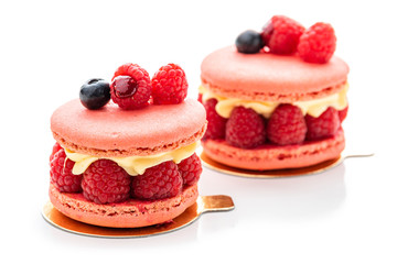 raspberry macaron. Two cakes with raspberries and cream on a white plate, isolate