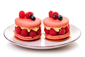 Raspberry macaron. Two cakes with raspberries and cream on a plate on a white background, isolate