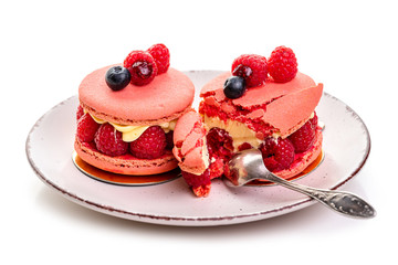 raspberry macaron. Two cakes with raspberries and cream on a plate on a white background, isolate