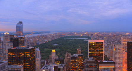 Aerial view on Manhattan roofs, central park and horizon with blue cloudy sky in Manhattan, New York