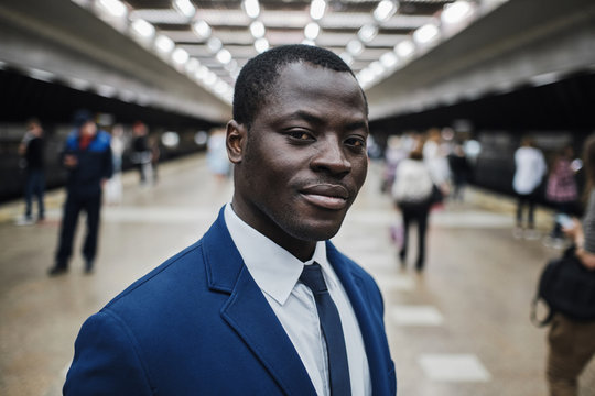 Smiling african businessman at subway