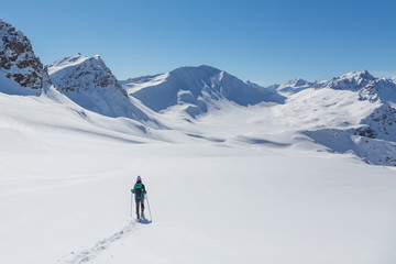 Fototapeta na wymiar one women with snowshoes in snowy winter landscape near Arosa Switzerland