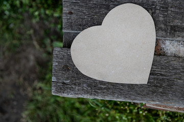 Paper heart on an old bench as a symbol of love