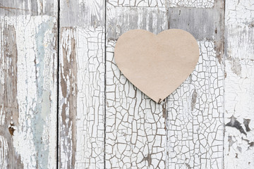 Paper heart on a rustic wall, door as a symbol of love