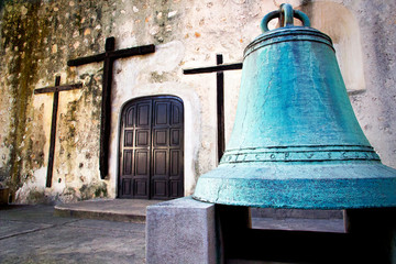 rosses and an old bell in a Mexican church in Merida, Mexico	
