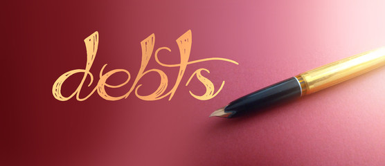 Debts word in gold and luxury pen on deep pink gradient. Financial obligations business concept