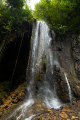 View of the fresh, noisy and intense water in Tumpak Sewu Waterfall, in East Java, Indonesia.
