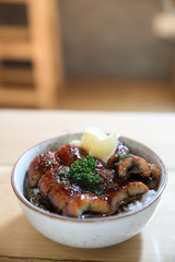 Japanese food unagi don , grilled eel on japanese rice on wood background