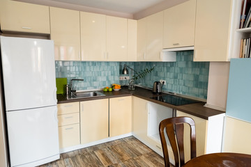 modern fridge near sink and faucet in modern kitchen