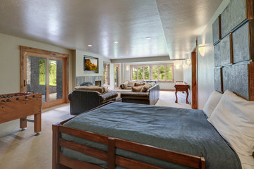 Amazing huge new luxury home family play room with soft natural wall color and light grey carpet with day bed.