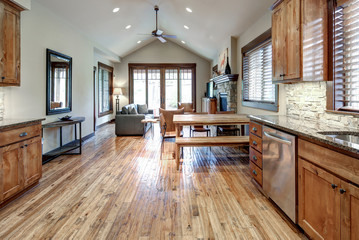 Luxury middle tone wood rich kitchen interior with grey natural stone  tiles backsplash and quarts countertop.