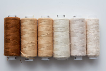 Color sewing threads on white background