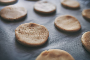 Round pieces of shortbread dough for making cookies or gingerbread