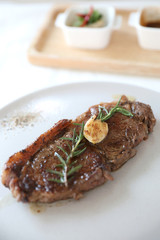beef steak with salad on white table