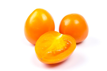Yellow fresh tomatoes isolated on white background in close-up