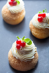Cake with whipped cream and berries. Choux pastry.