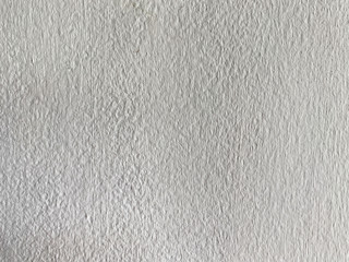 Gray white Plaster Wall, with light and shadows falling . Rough Surface. Old Weathered Painted Background Texture. Vintage Timber Background. Peeled Plaster Brickwall.