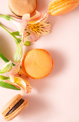 macaroons with Alstroemeria flowers on a beige background