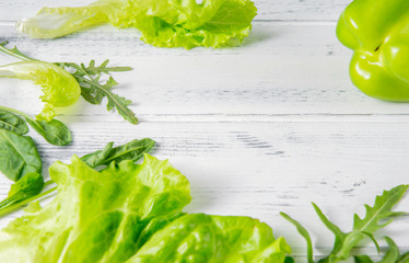Obraz premium pepper, lettuce leaves, arugula , green spinach, herbs on a white