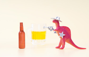 Toy dinosaur wearing a cowboy hat, holding a revolver in his arm and having a sheriff star shoots...