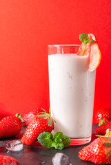 milkshake with strawberries, fresh strawberries on a red background, yogurt with red berries