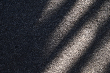 Cement textured wall background with palm tree shadow for product photos & fashions backgrounds.