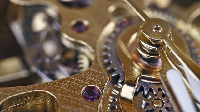 Sliding shot over clock mechanism running gear in extreme macro 4k