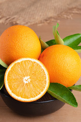 orange.orange fruits background many orange fruits. Oranges group freshly picked in a basket and on a brown wooden table