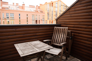 wooden table and chair on modern balcony