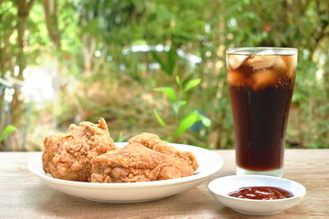 fried chicken and French fries with cola on table