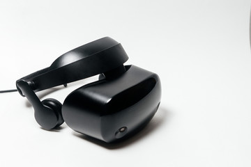 Original black stereoscopic 3d vr mask with headphones, with controller. Isolated on white background.